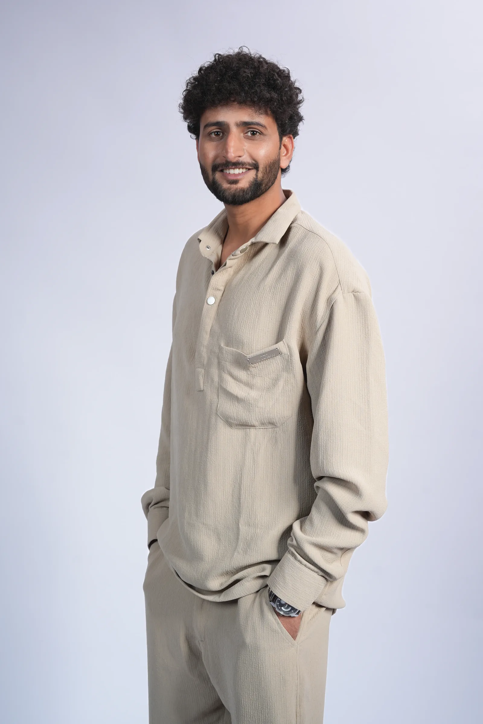 Studio headshot, warm smile