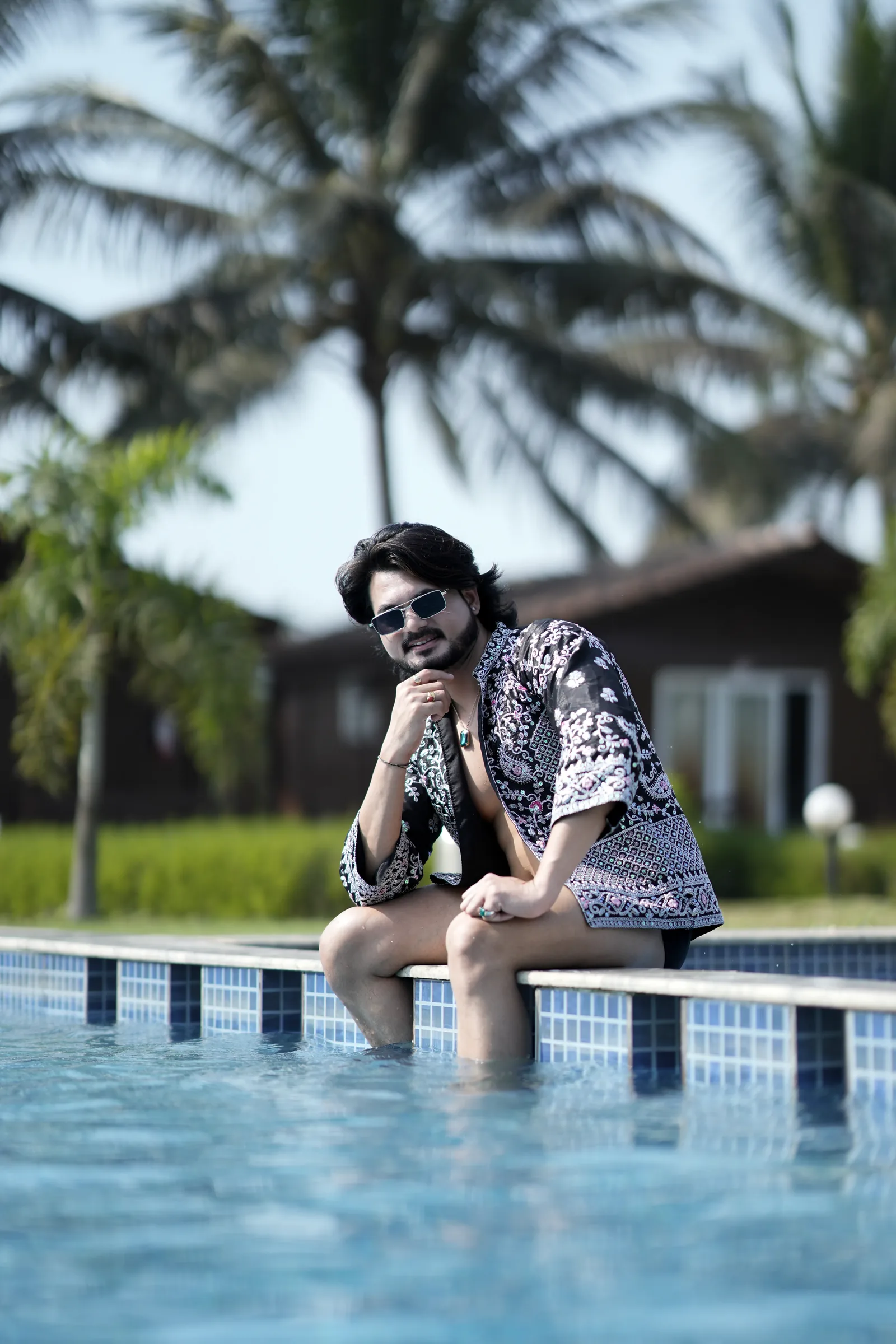 Model seated poolside in patterned kimono