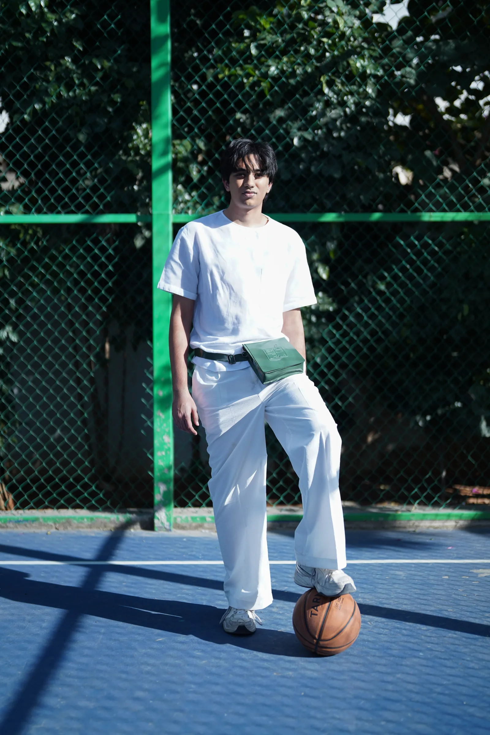 Model with green bag on a basketball court