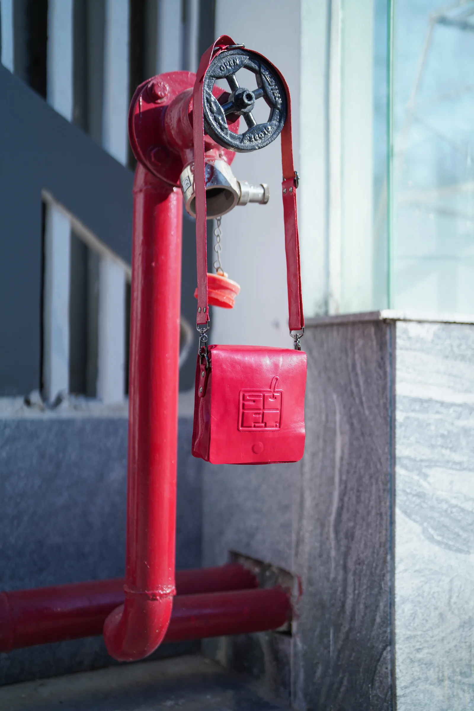 Red bag hanging on a fire hydrant